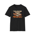 Black “The Low End Called” T-shirt featuring a hand playing a retro synthesizer, cream lettering, and an orange-and-gold waveform.