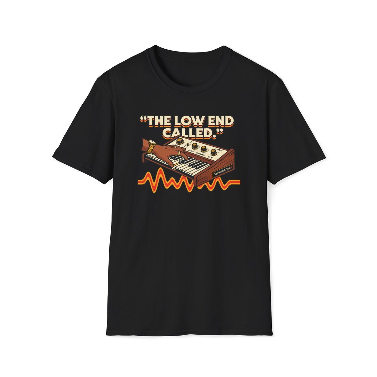 Black “The Low End Called” T-shirt featuring a hand playing a retro synthesizer, cream lettering, and an orange-and-gold waveform.